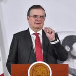Economy Minister Marcelo Ebrard gestures from a press conference podium