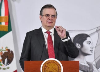 Economy Minister Marcelo Ebrard gestures from a press conference podium