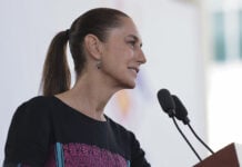 President Sheinbaum speaks into a microphone