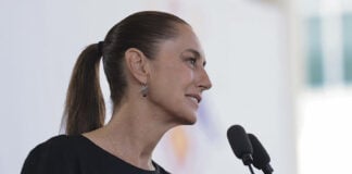 President Sheinbaum speaks into a microphone