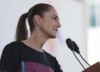 President Sheinbaum speaks into a microphone