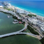 An aerial view of an under-construction bridge leading to the thin peninsula that is Cancún's hotel zone