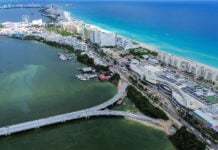 An aerial view of an under-construction bridge leading to the thin peninsula that is Cancún's hotel zone