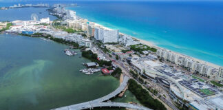 An aerial view of an under-construction bridge leading to the thin peninsula that is Cancún's hotel zone