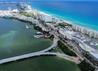 An aerial view of an under-construction bridge leading to the thin peninsula that is Cancún's hotel zone