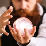 A bearded man stares into a crystal ball
