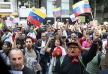 Protesters shout and wave Venezuelan flags in Mexico City