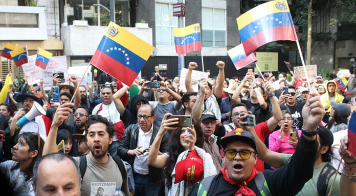 Protesters shout and wave Venezuelan flags in Mexico City