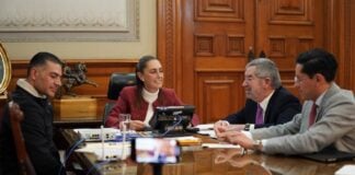 Mexico's president sits at a round table while on a phone call with U.S. President Trump