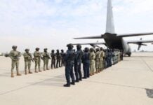 members of Mexico's military lined up and preparing to transfer criminals to the United States by airplane