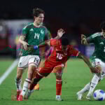 Kevin Galván (16) of Panama takes on Mexico's Richard Ledezma (number 27) and Marcel Ruiz (14)