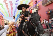 A woman riding a black horse