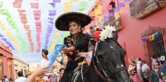 A woman riding a black horse