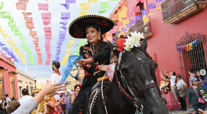 A woman riding a black horse