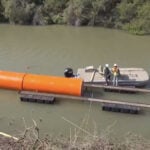 Orange water buoys installed in the Rio Grande as part of a push by President Trump to build more walls at the U.S.-Mexico border