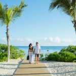 a couple enjoys an Excellence Group resort at the beach