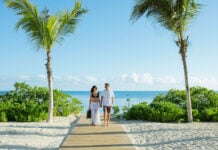 a couple enjoys an Excellence Group resort at the beach