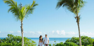 a couple enjoys an Excellence Group resort at the beach