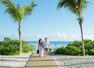 a couple enjoys an Excellence Group resort at the beach