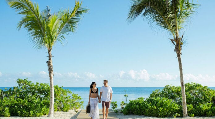 a couple enjoys an Excellence Group resort at the beach