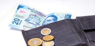 Mexican peso bills and coins with a wallet