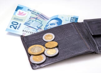 Mexican peso bills and coins with a wallet