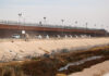 A convoy of U.S. Border Patrol vehicles drives the Mexico-U.S. border near El Paso, Texas.