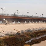 A convoy of U.S. Border Patrol vehicles drives the Mexico-U.S. border near El Paso, Texas.