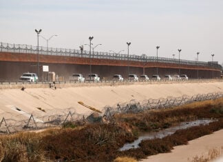 A convoy of U.S. Border Patrol vehicles drives the Mexico-U.S. border near El Paso, Texas.