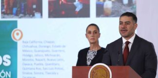 Omar García Harfuch at a podium