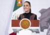 President Sheinbaum smiles from the podium of her morning press conference.