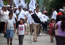 A security guard carrying a covered long gun at a political event
