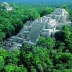 Structures I and II of the Calakmul archeological site are vast, stepped pyramid-like structures emerging out of the jungle in Campeche, Mexico.