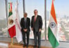 Mexico’s Economy Minister Marcelo Ebrard and India’s Ambassador to Mexico Panka Sharma pose with Mexican and Indian flags