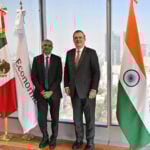 Mexico’s Economy Minister Marcelo Ebrard and India’s Ambassador to Mexico Panka Sharma pose with Mexican and Indian flags
