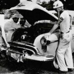 Hershel McGriff oversees repairs on his “City of Roses” Oldsmobile during the first running of the Carrera Panamericana in Mexico in 1950. (NASCAR Hall of Fame)