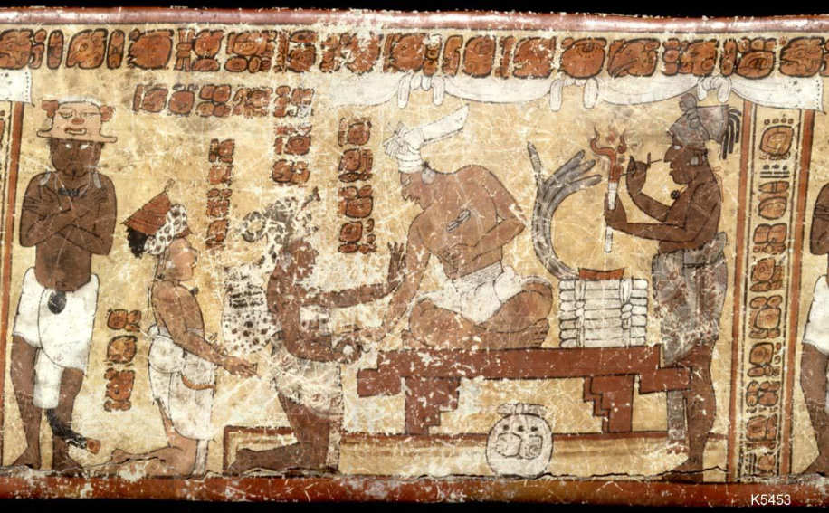 Close up of the design on a ceramic vase found at the Tikal archeological site in Guatemala. It shows ambassadors visiting the court of the Tikal ruler, Jasaw Chan K’awiil.