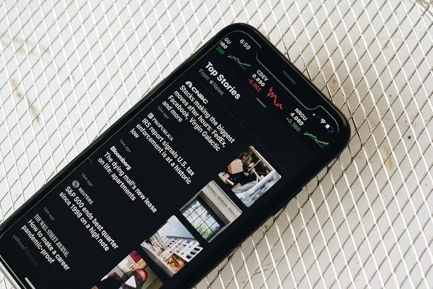 A smartphone showing various news headlines