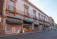 Mexico City, Mexico – August 15, 2020: Empty streets while the Covid pandemic took on the city and posters warning people to stay inside their houses