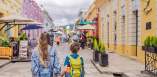 A blonde mother and child walk down the streets of San Cristobal, Chiapas.