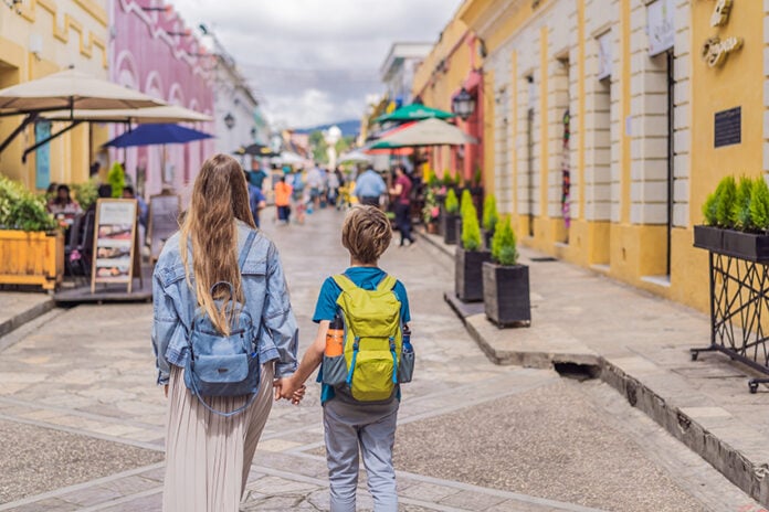 A blonde mother and child walk down the streets of San Cristobal, Chiapas.
