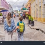 A blonde mother and child walk down the streets of San Cristobal, Chiapas.