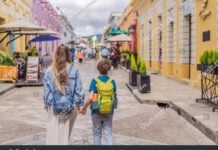 A blonde mother and child walk down the streets of San Cristobal, Chiapas.