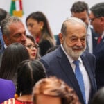 Mexican billionaire Carlos Slim Helú and his son in a crowd at the Mexican National Palace