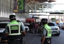 National Guardsmen watch cars pull up to terminal 2 of Mexico City International Airport