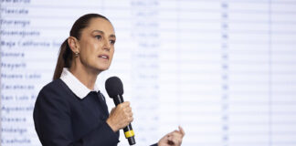 President Sheinbaum speaks into a microphone at a press conference