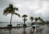 A car drives down the flooded ocean-front malecón of La Paz in 2022 after Hurricane Kay