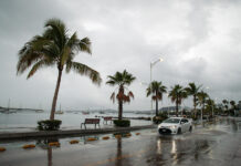 A car drives down the flooded ocean-front malecón of La Paz in 2022 after Hurricane Kay