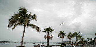 A car drives down the flooded ocean-front malecón of La Paz in 2022 after Hurricane Kay