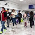 Passengers walk through a terminal at Mexico City International Airport